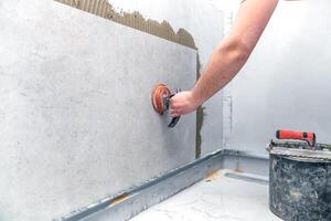 craftsman tiling the room with large format tiling photo