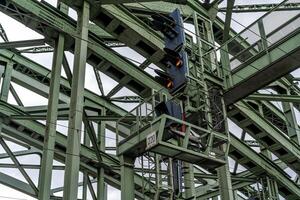 traffic lights for trains on the metal bridge of the railway line photo