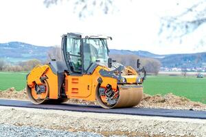 roller for asphalt compaction during the construction of a new road and traffic communication photo