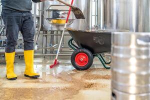 cleaning the boiler from residual malt after brewing beer in the brewery photo