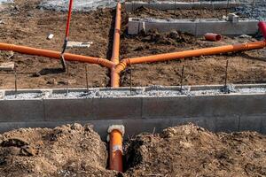plastic pipe for sewage network in the base plate at the construction site photo