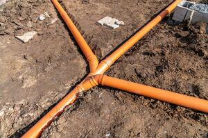plastic pipe for sewage network in the base plate at the construction site photo