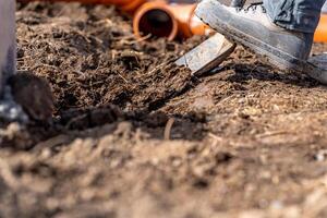 digging in the ground for plastic pipes for water and waste. photo