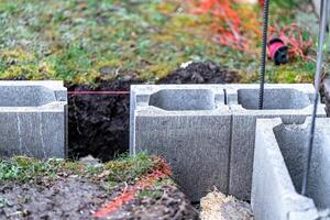 the foundation of the house is made of concrete blocks bound with metal armature photo