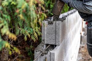 pour concrete from the mixer of the foundation of the building in the ground photo