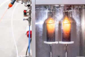 machine for washing and filling glass bottles with beer photo