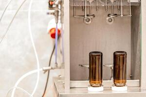 machine for washing and filling glass bottles with beer photo