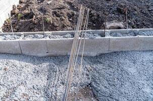 concrete foundation of the building with metal reinforcement photo