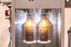 machine for washing and filling glass bottles with beer photo