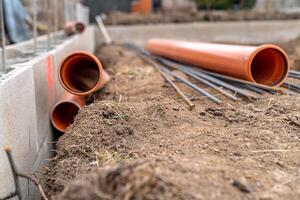 plastic pipe for sewage network in the base plate at the construction site photo