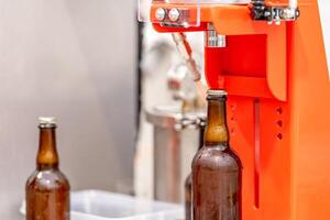 capping beer bottles in a brewery photo