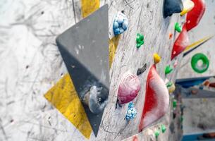 artificial climbing wall with colorful holds photo