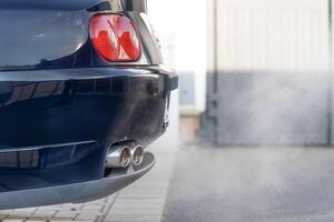 smoke from the exhaust of a car with a gasoline engine photo