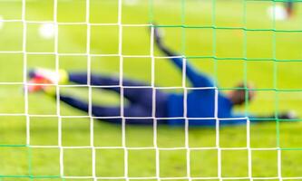 Blurred view soccer goalkeeper in the goal photo