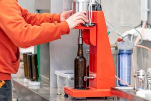 capping beer bottles in a brewery photo