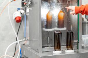 machine for automatic filling of beer bottles in a brewery photo