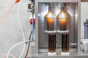 machine for automatic filling of beer bottles in a brewery photo