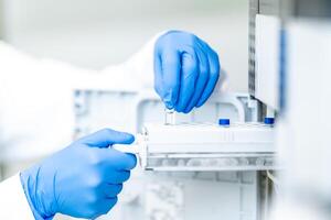 examination of a chemical sample using modern devices in the biochemical laboratory of the research institute photo