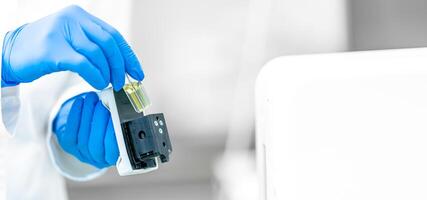 examination of a chemical sample using modern devices in the biochemical laboratory of the research institute photo