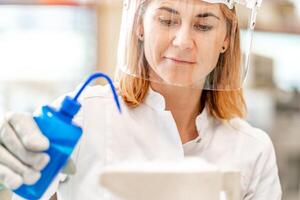 woman in mask, student of the university' science faculty conducts biochemical research in the laboratory photo