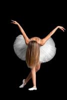 portrait of a ballerina in a pose, black background photo