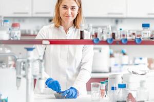 a female student at the science faculty of the university conducts biochemical research in the laboratory photo