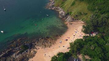 An aerial view of a beach surrounded by trees and a body of water. Yanui beach in Phuket. Kingdom of Thailand video