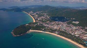 An aerial view of a small island in the middle of the ocean surrounded by mountains. View of Kata and Karon beach, Phuket island, Kingdom of Thailand video