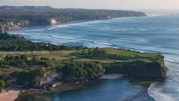 Bali coastline with ocean and perfect swell waves. Drone view of scenic landscape video