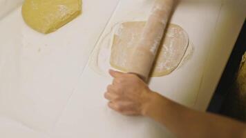 Rolling Dough with Rolling Pin on Table. Slow Motion. High Angle Shot video