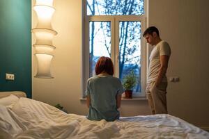 Upset woman and man in difficult period of life. Sad couple after argument, domestic quarrels photo