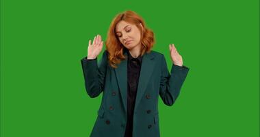 Female red haired doubting and shrugging shoulders as indecision and insecurity over green screen background. video