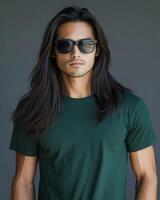 Handsome model poses confidently wearing a blank green t-shirt and sunglasses photo