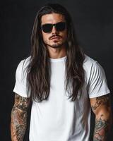 Model in a blank t-shirt poses confidently with long hair and tattoos photo