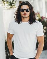 A good-looking model in casual attire poses confidently with his hands in pockets photo