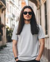 A confident model showcases a blank t-shirt while standing in a chic alley photo