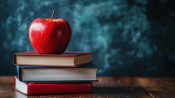 A book with an apple on top of it photo