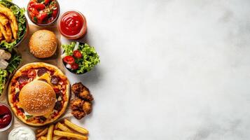 Top view of fast food, pizza box, burger and chicken strips on a white background with copy space. photo