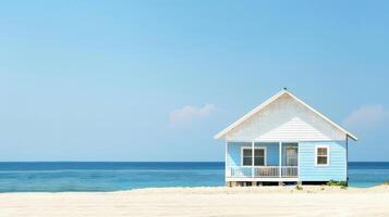 A charming blue cottage stands near the peaceful ocean under a clear sky photo
