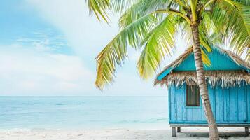 A peaceful blue hut rests under swaying palm trees by the ocean photo