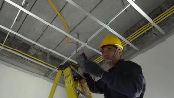 An electrician in uniform is inspecting the electrical system in a house. video