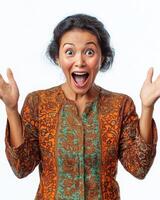 A woman joyfully raises her hands in delight, wearing colorful traditional attire photo
