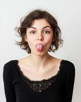 A woman expresses her playful side by sticking out her tongue photo