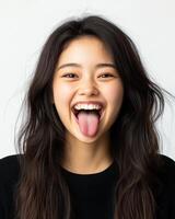 A cheerful girl expresses joy with a playful gesture of sticking out her tongue photo