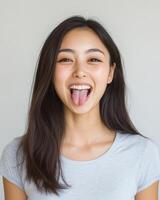 A smiling girl with long hair playfully expresses her joy photo