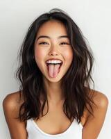 A cheerful girl expresses happiness with a playful tongue gesture photo