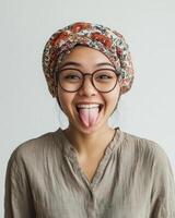 A cheerful young woman shows her playful side with a bright expression photo