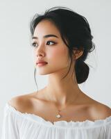 A young woman with elegant features reflects in soft morning sunlight photo