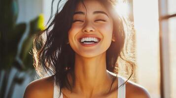 Bright sunlight illuminates a woman's joyful expression and flowing hair photo