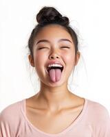 A cheerful teenager expresses playfulness with a big smile and tongue out photo